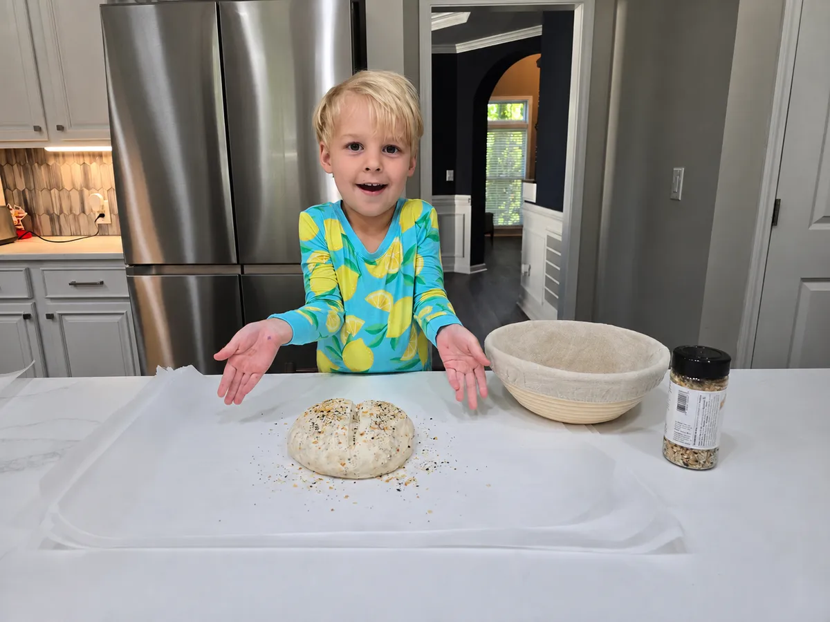 Sourdough dough being shaped by hand on a work surface